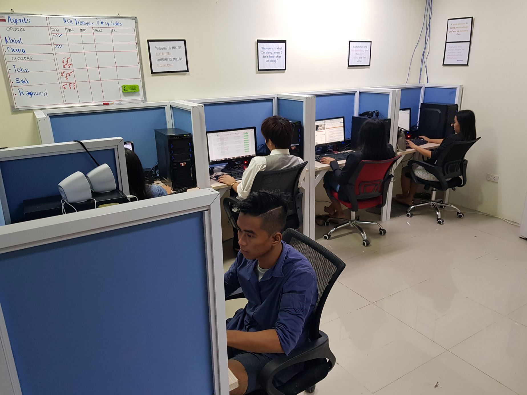 OBI Services team members working at their desks in a call center environment.