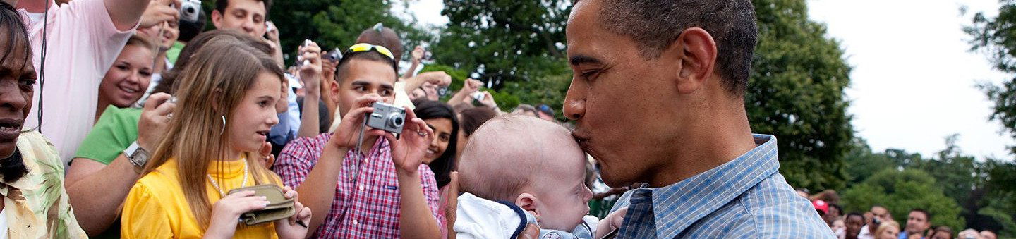 Banner for 'Understanding political communication' resource. Shows Barack Obama kissing the forehead of a baby with a crowd of onlookers.