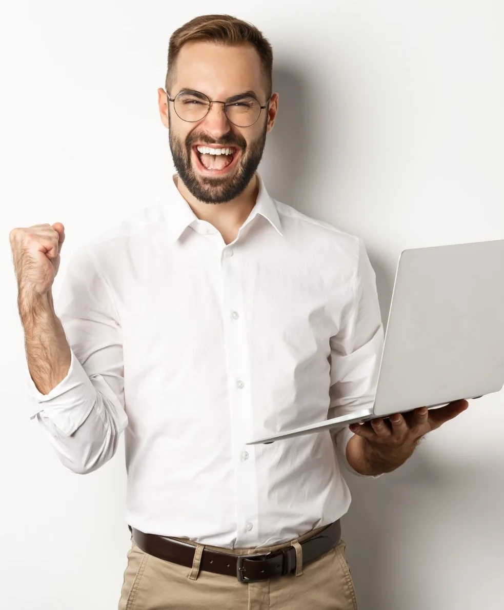 Business happy manager winning online rejoicing with fist pump holding laptop triumphing standing