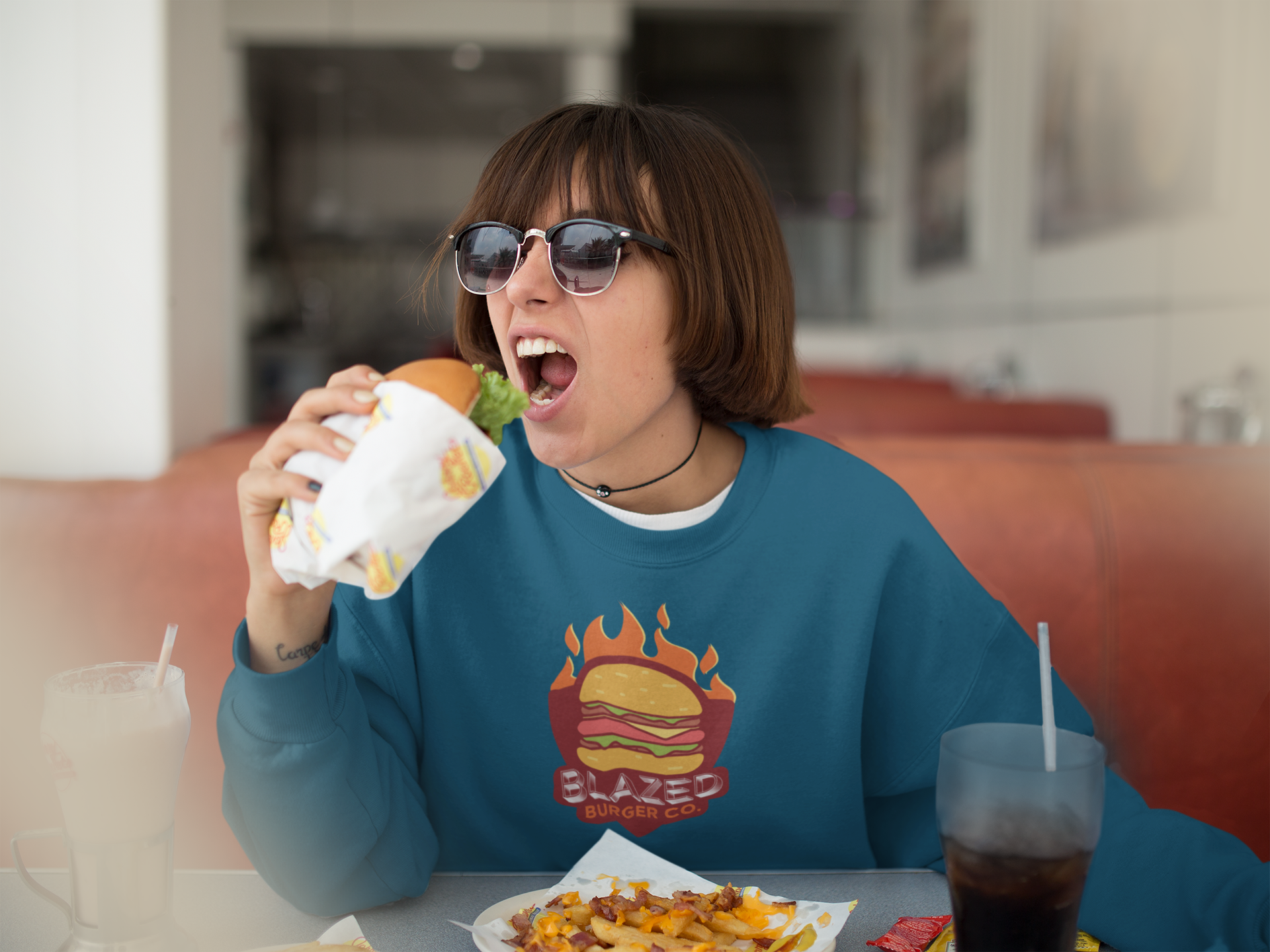 Crewneck mockup of a trendy girl with sunglasses and short hair eating a burger a12658