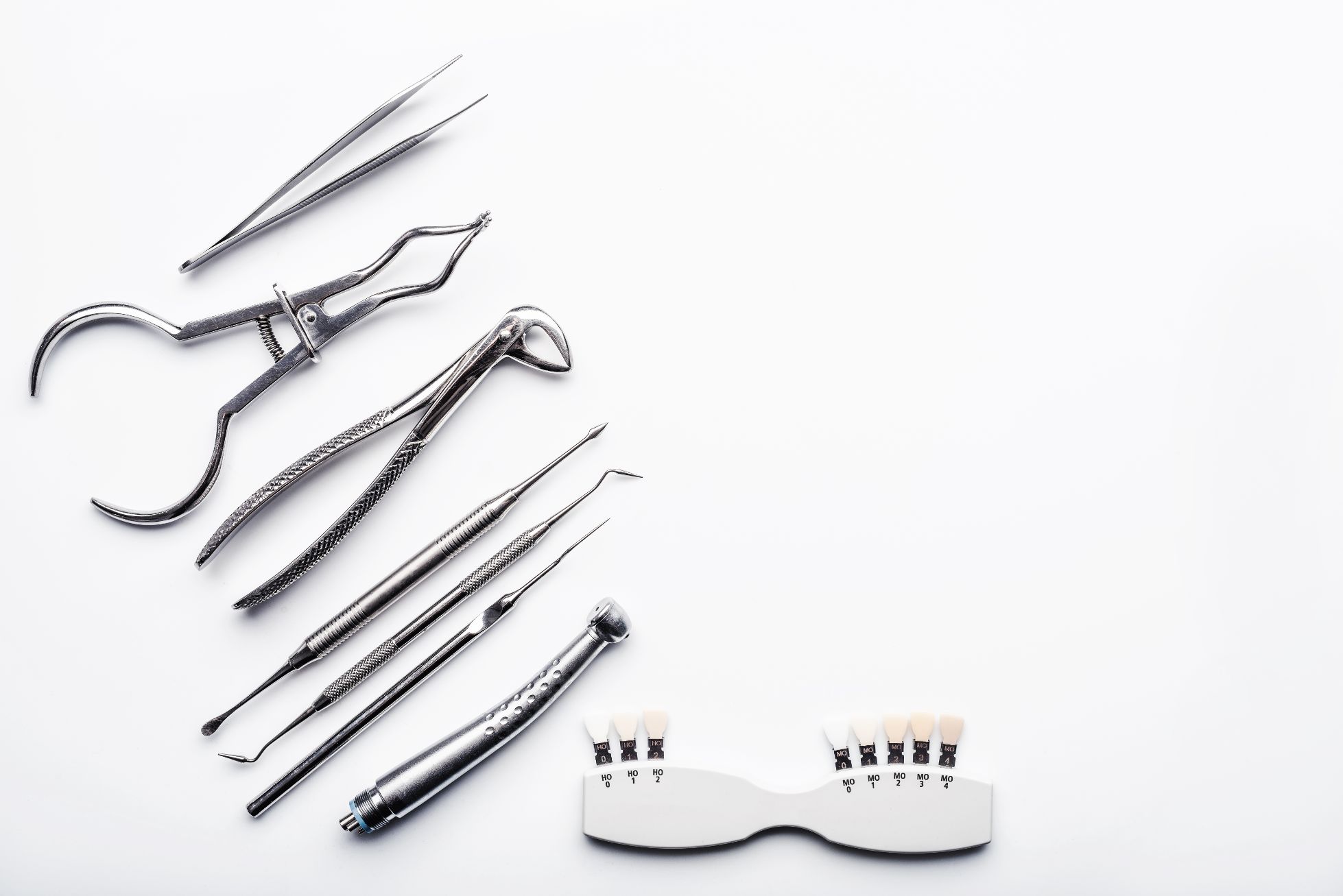 Different shiny metal medical tools white background